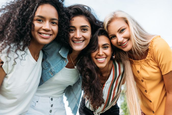 Group of diverse women smiling outside