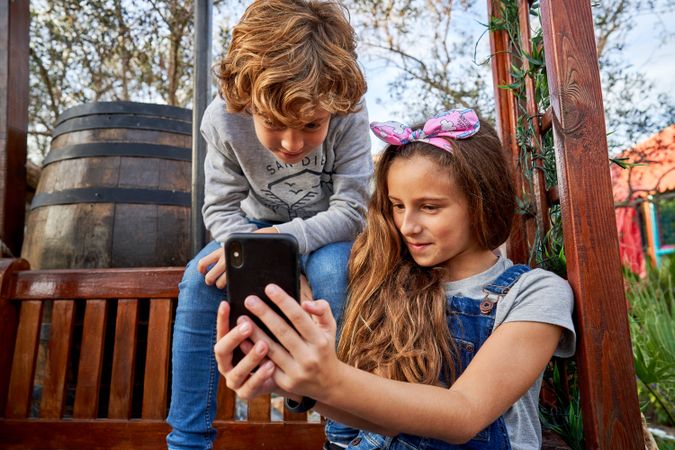 Children watching video in backyard