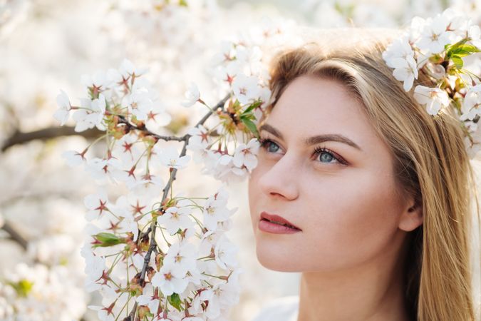 woman amidst white flowers