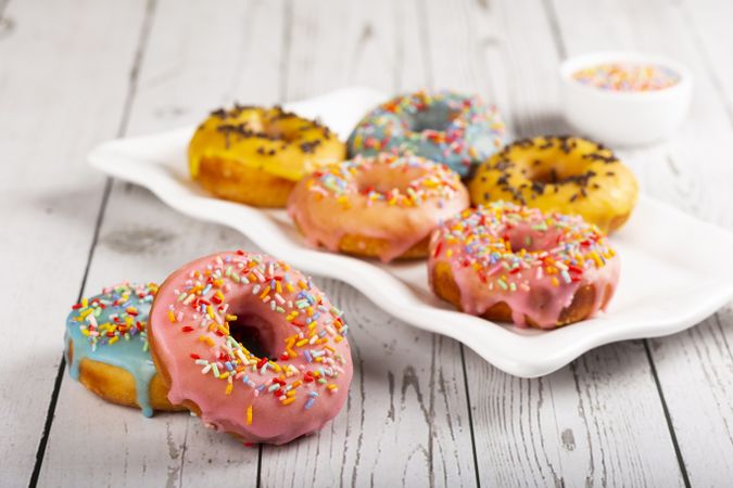 Delicious assorted colorful donuts on the table.