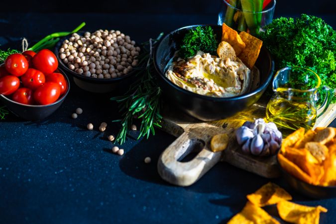 Traditional hummus spread with veggies and chips to dip