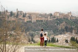 Back of mother and daughter overlooking beautiful Spanish town 5XvZVb