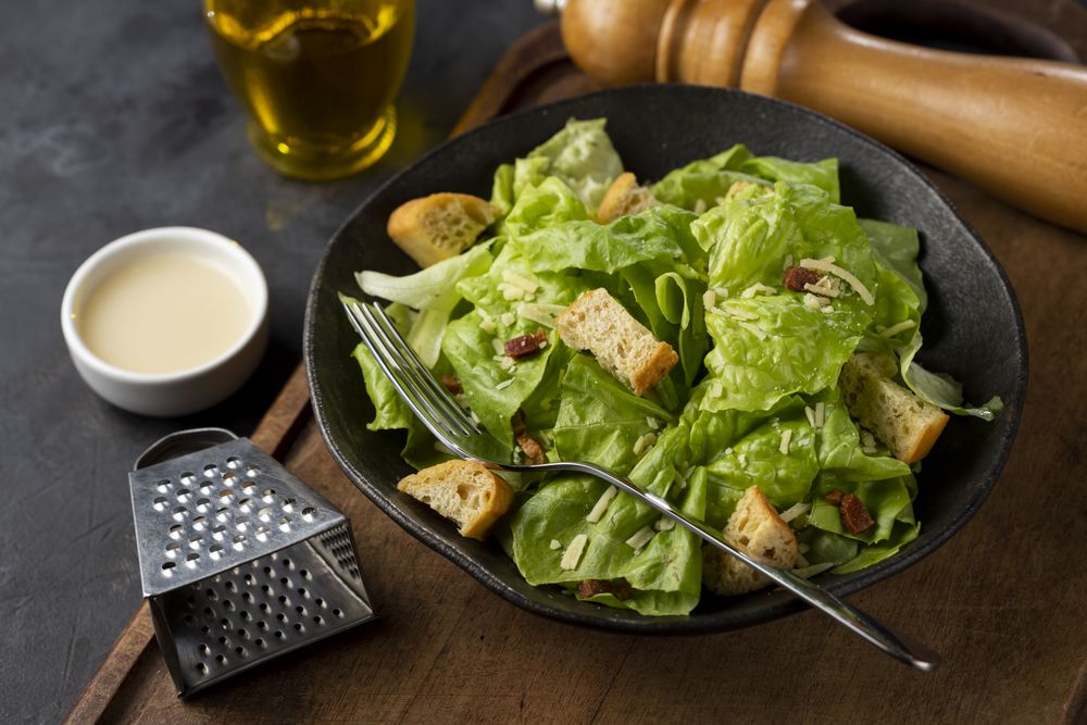 Caesar salad with croutons and bacon.