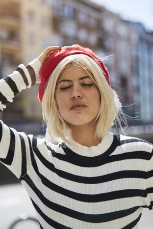 female in red beret outdoors