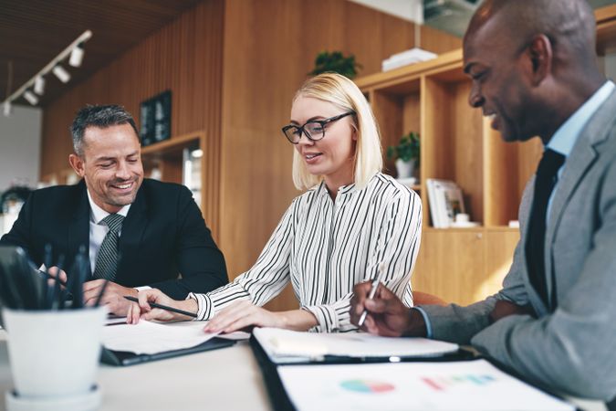 Group of smiling people working together in an office