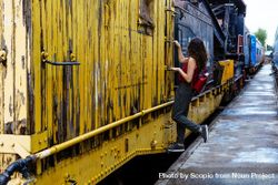 Woman holding on yellow train bYkeg5
