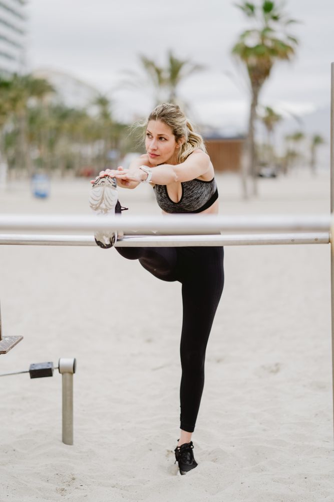 Sportswoman doing workouts in a sandy beach