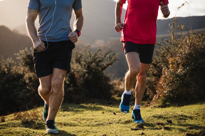 Sportive men running in mountains