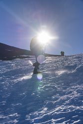 Tourist gazing at breathtaking snowy mountain slope