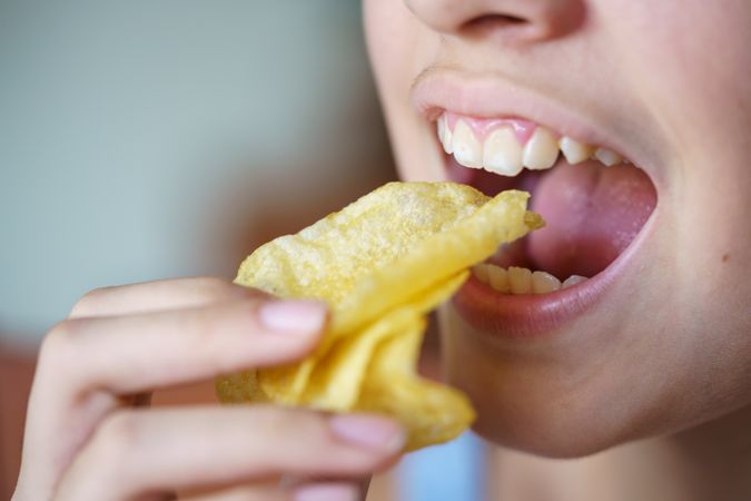 Girl biting into chips