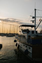 Luxury yachts in port at sunset