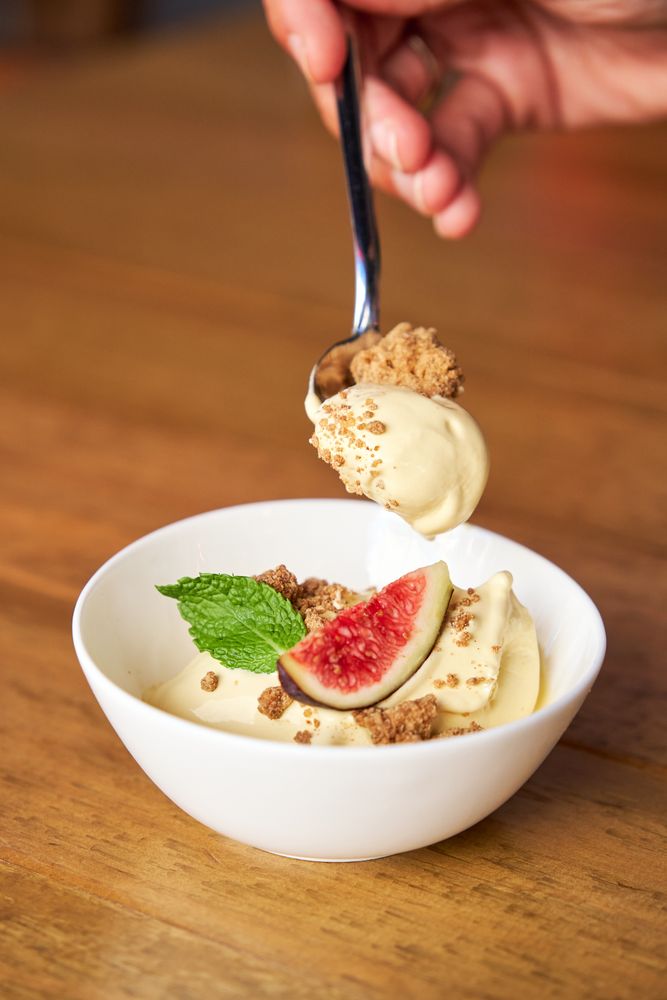 Vertical photo of a spoon grabbing some prickly pear mousse