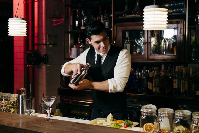 Barman working mixing drinks in a shaker