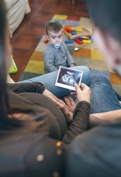 Parents looking at ultrasound of their new baby