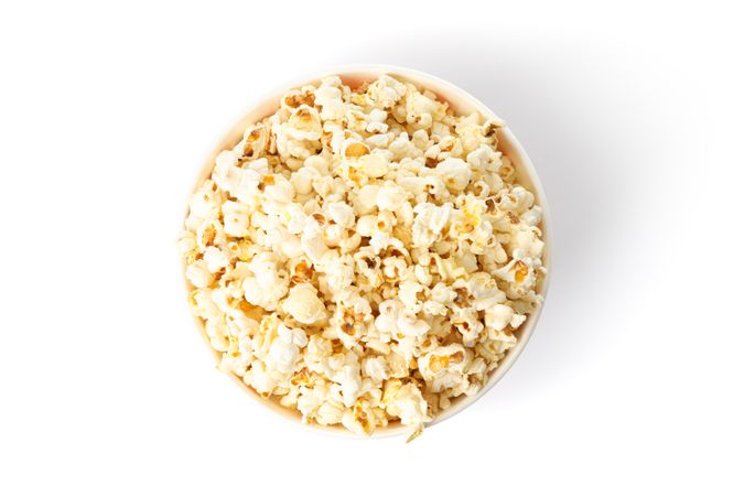 Striped bucket with popcorn isolated on blank background, top view