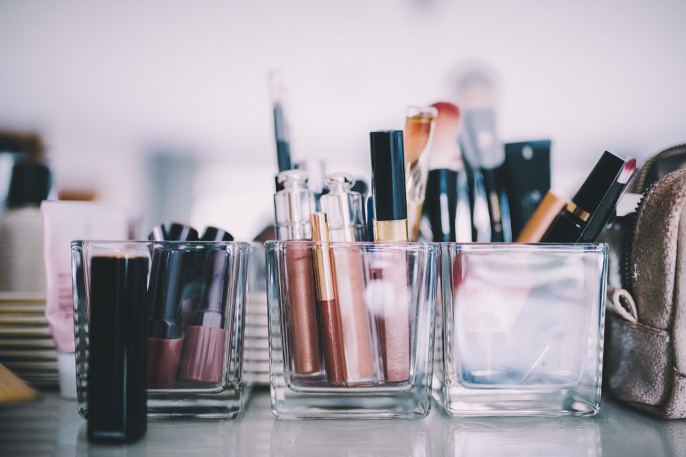 Make up, brushes and lipsticks on the counter