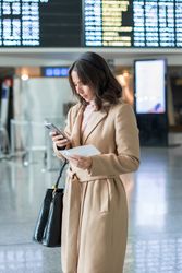 Woman using smartphone at airport