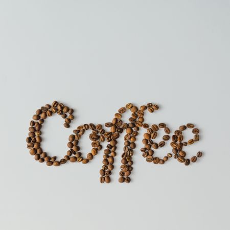 Coffee beans spelling out “Coffee” on bright background