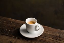 Cups of tasty hot coffee drink on wooden table