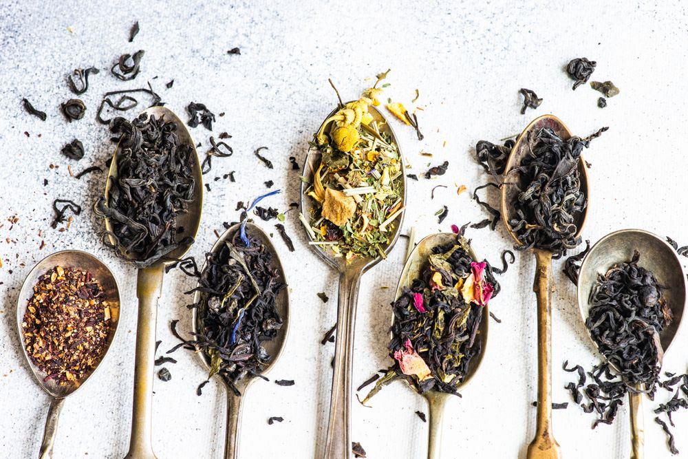 Top view of loose leaf tea in vintage spoons