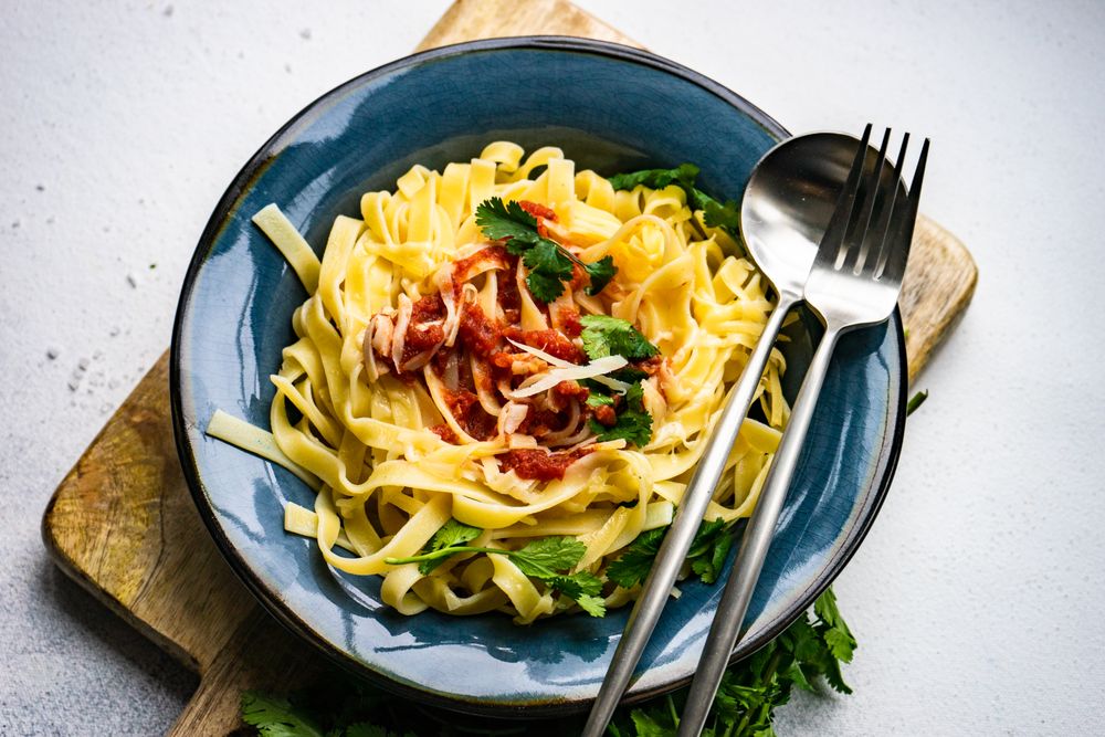 Pasta with cheese on counter with copy space