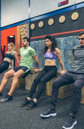 Athletes exercising doing box squats