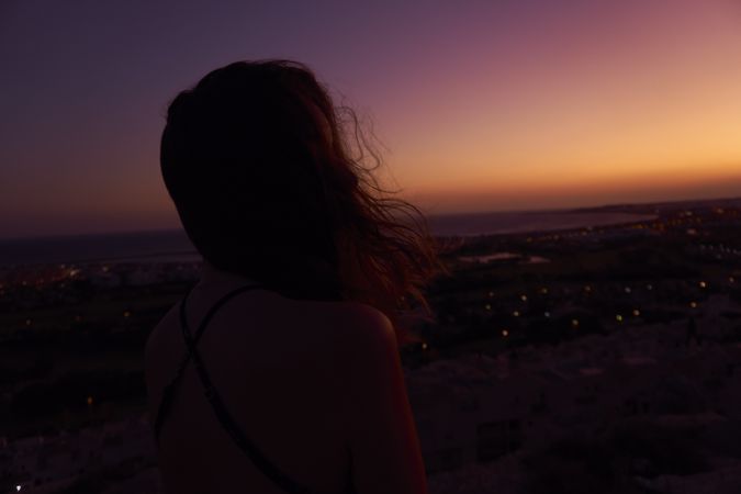 Silhouette of female enjoying picturesque sunset