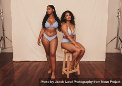 Body positive young women posing against a studio background 0PLwa0