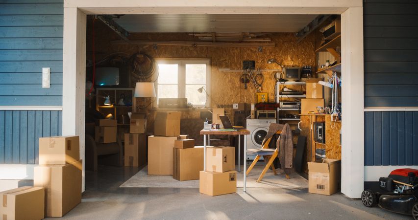 Establishing Shot Of Small Business Owners Empty Workplace With Laptop In Garage.