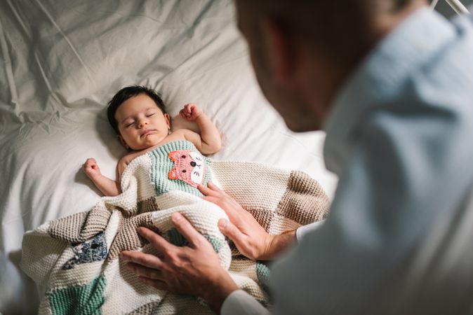 Anonymous father wishing good night to baby