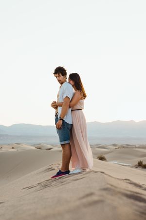 Tender couple hugging in sandy desert valley
