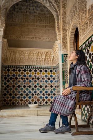 Asian woman resting in ancient palace