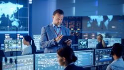 Diverse Team in a Tech-driven Control Room Analyzes Global Data on Multiple Screens, Ensuring Cybersecurity. the Atmosphere Is Collaborative and Focused
