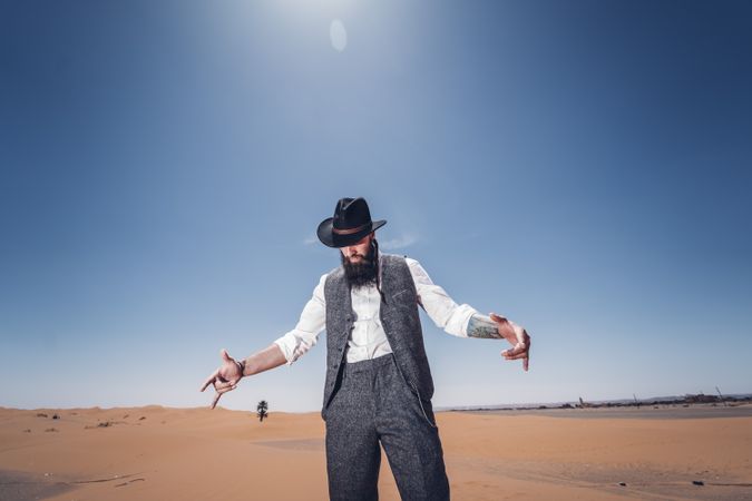 Bearded cowboy in desert