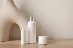 Blank beauty bottles on wooden table