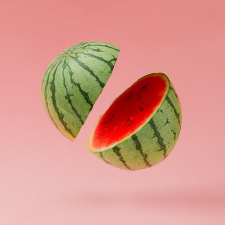 Watermelon slices on pastel pink background with copy space