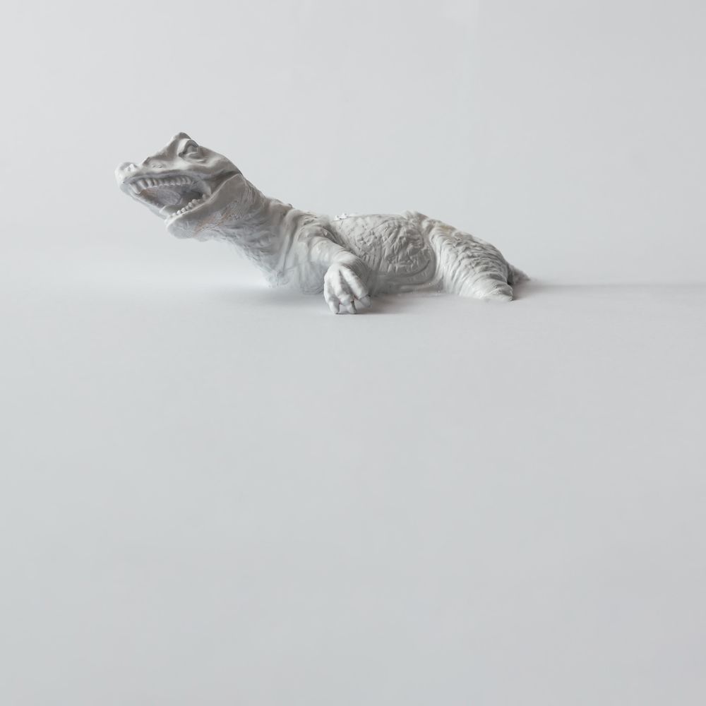 Painted dinosaur on light flat background