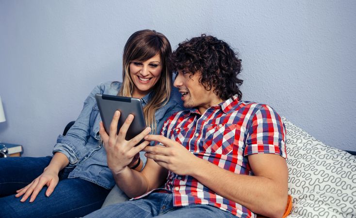 Couple watching something on tablet