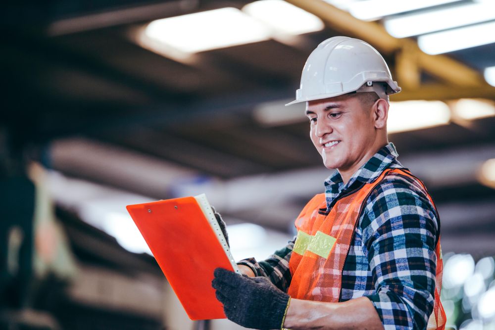Smiling construction man with clipboard