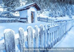 Frozen wooden fence and rustic chapel 4dDoa4