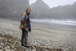 Older man on empty ocean seashore