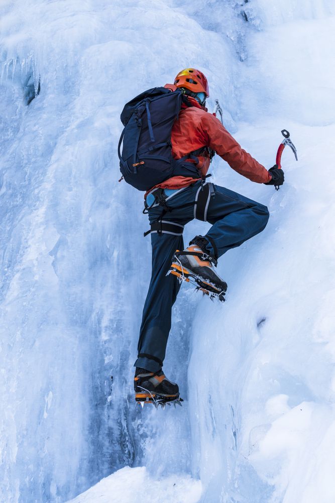 Confident climber using equipment for ice climbing