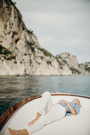 Woman lying on boat in the sea