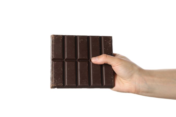Female hand holding chocolate bar, isolated on blank background