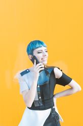 Cheerful futuristic woman talking on smartphone