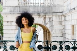 Stylish female leaning on railing outdoors