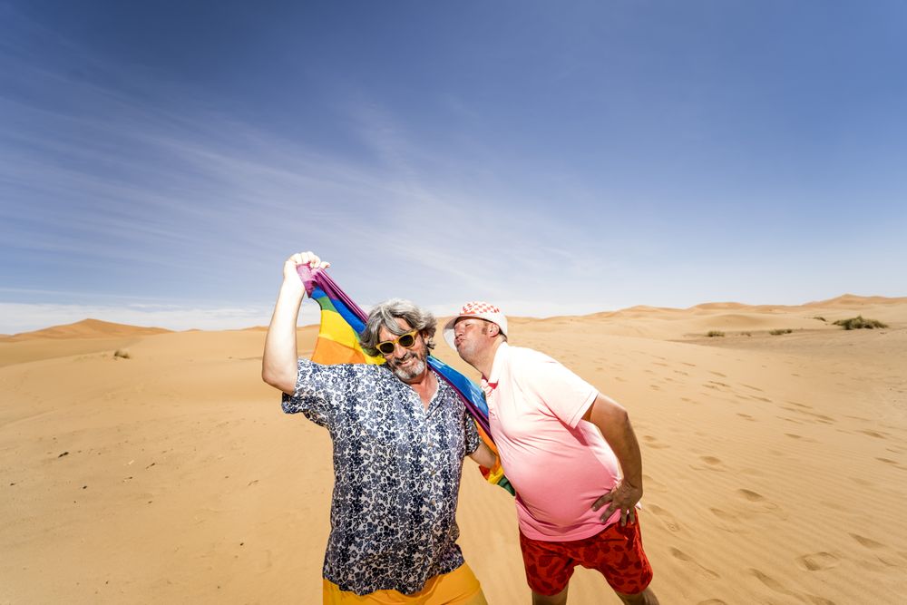 Excited gay couple in desert