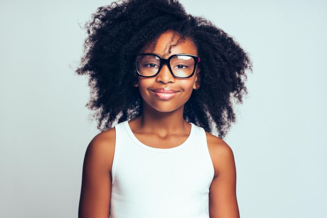 Portrait of confident smiling girl wearing oversized glasses