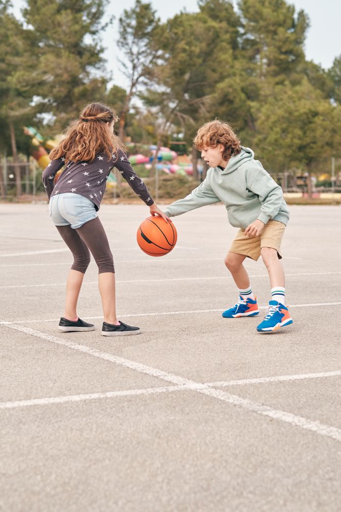Teen friends playing basketball together