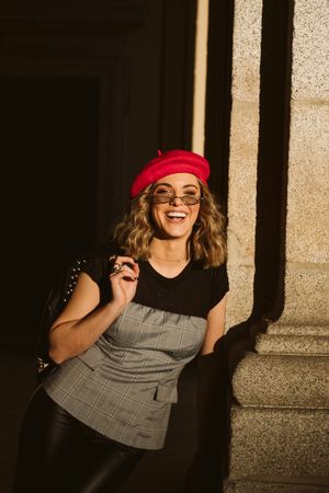 Stylish female standing near building wall